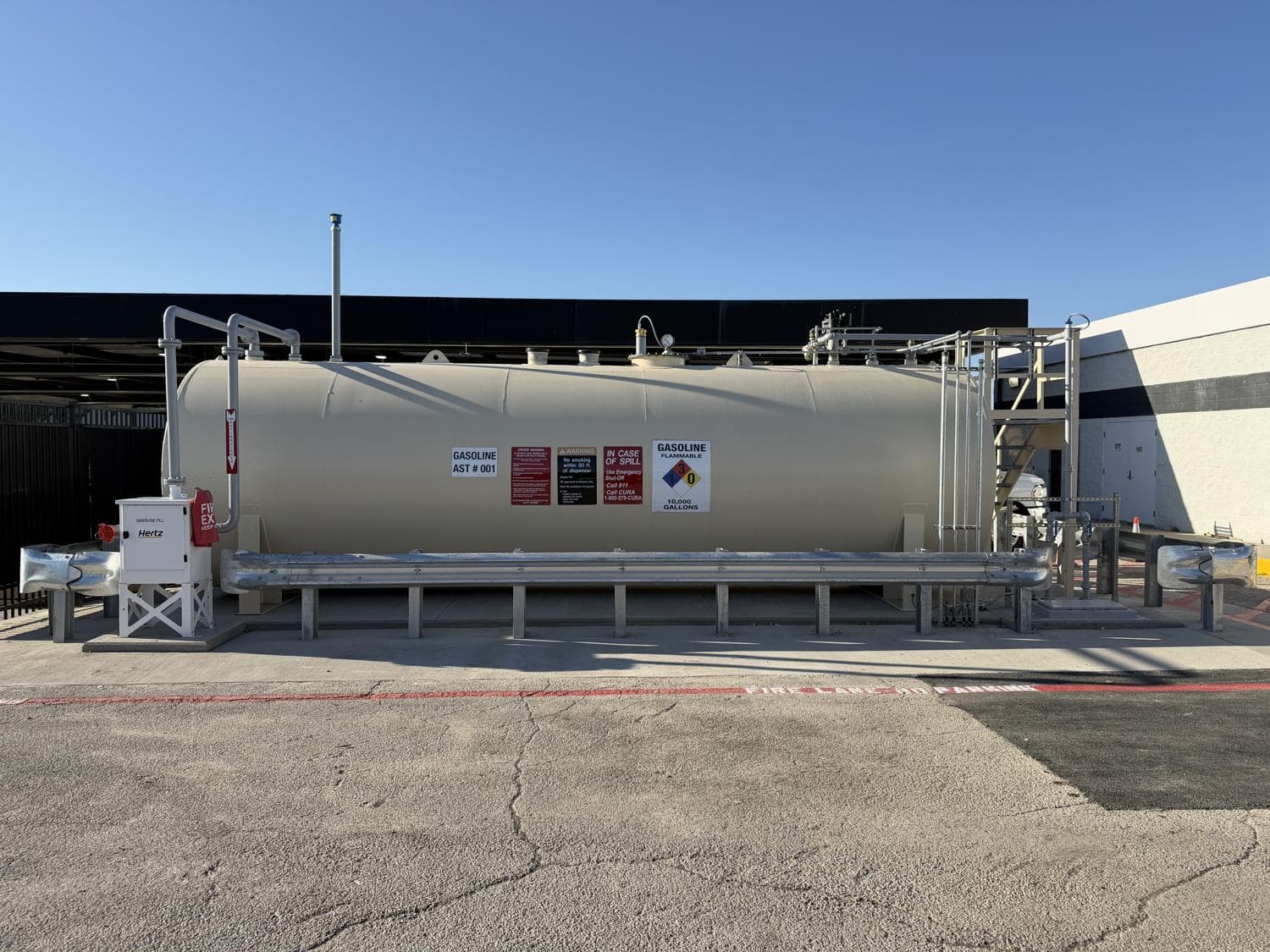Completed aboveground gasoline tank with access stairs, remote fill and vehicle protection at the Dallas rental-car facility