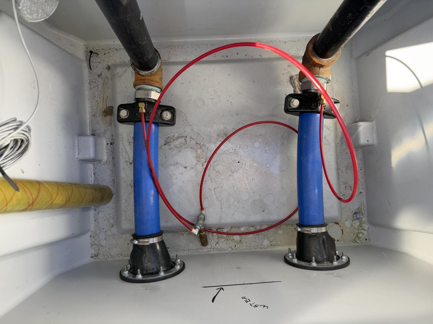 Interior of the transition sump showing product-piping entries and connections