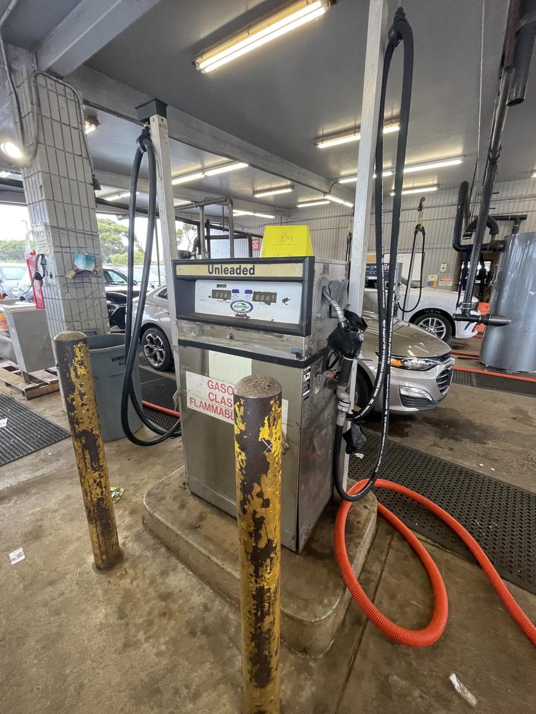 An existing the rental-car facility dispenser in the vehicle-servicing area