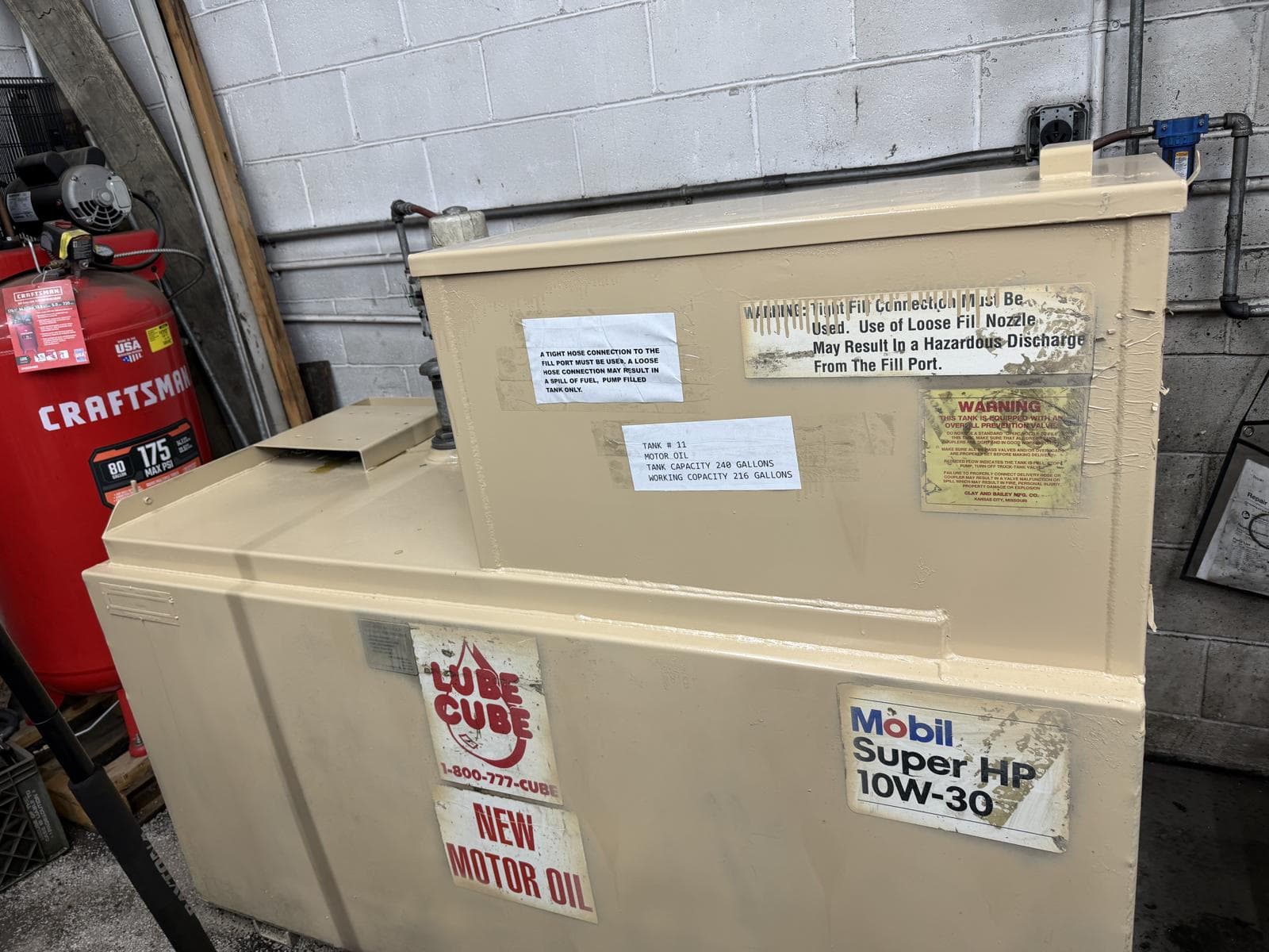 Retained 240-gallon motor-oil tank with updated finish and labeling