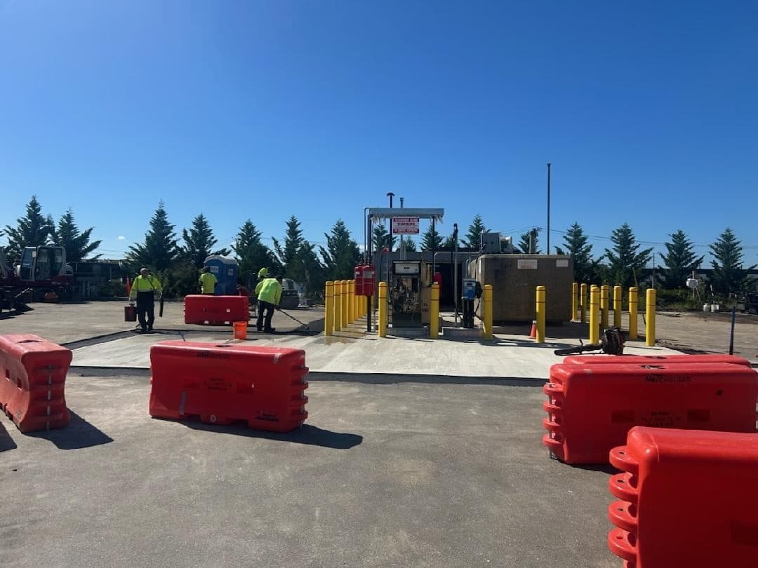 Wide view of the installed outdoor fueling island during site finishing work