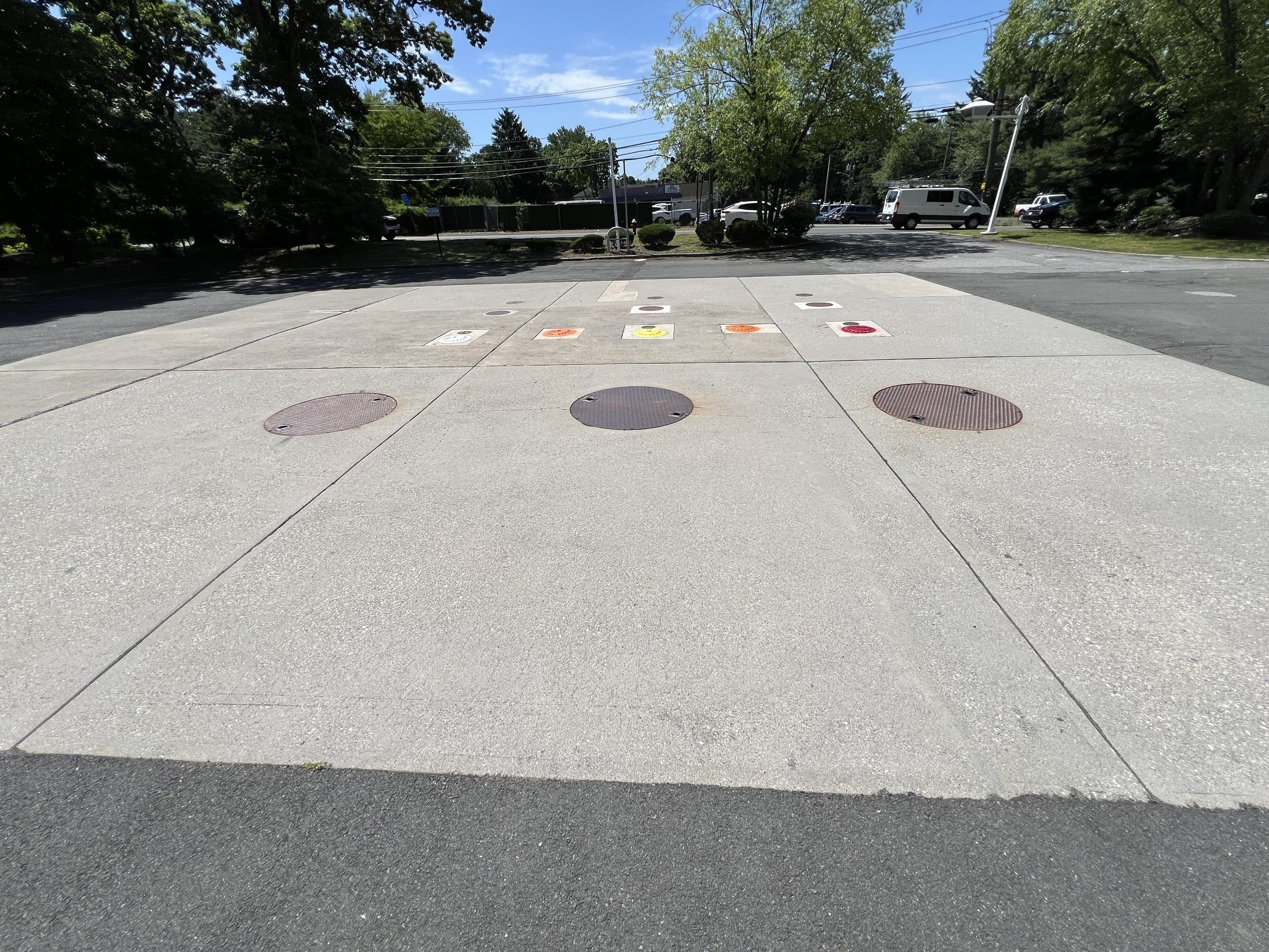 Underground tank access covers and fill points at a fueling facility.