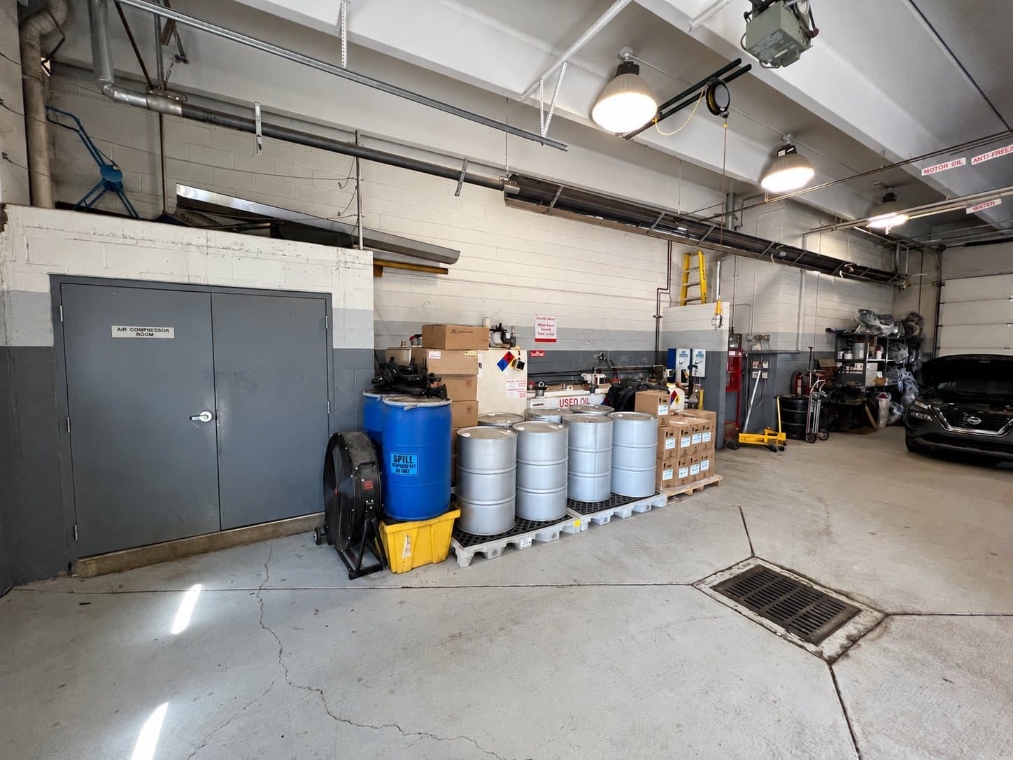 Oil tanks, drums and spill-response equipment within a repair facility.