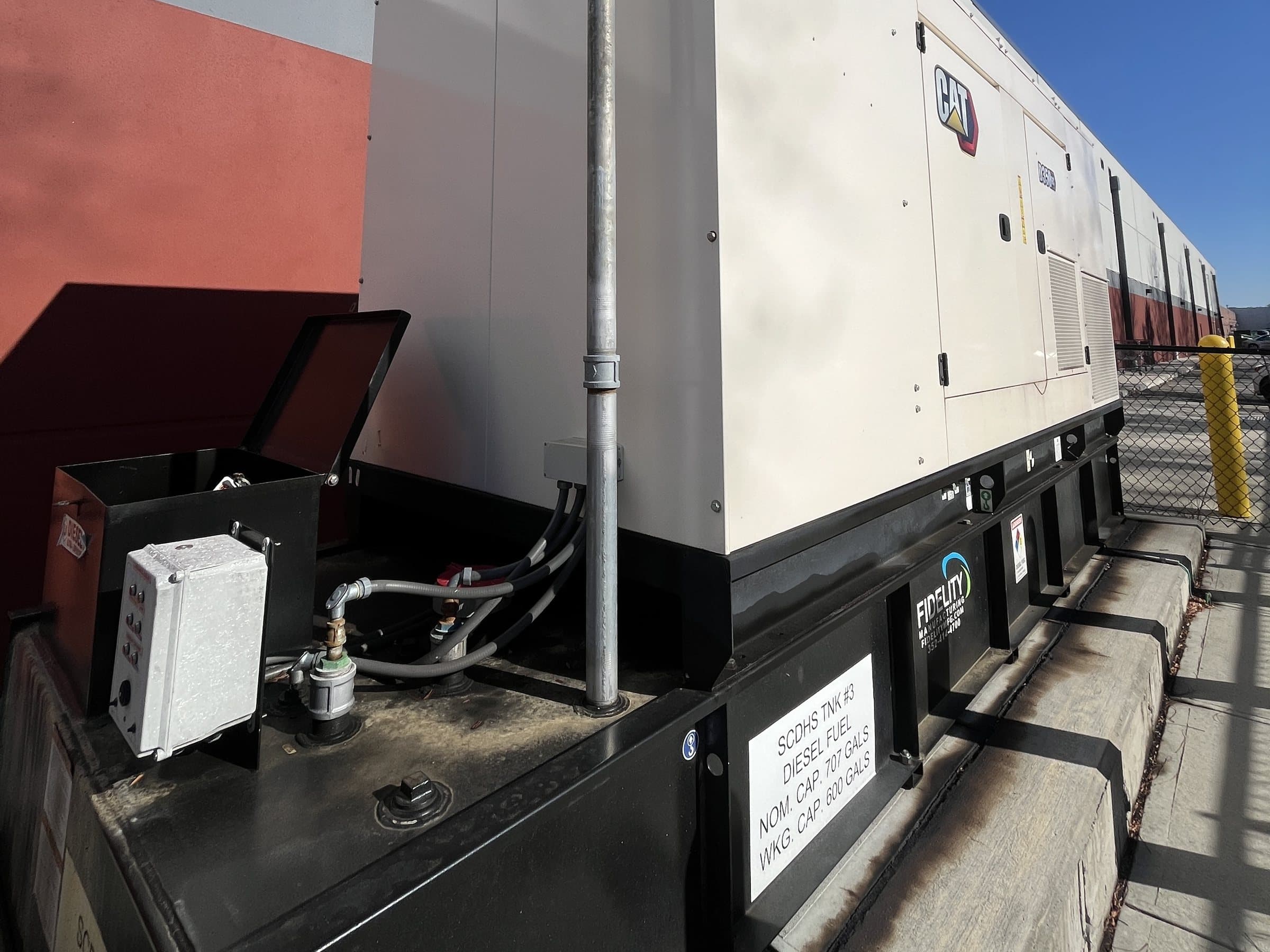 Emergency generator enclosure, base fuel tank and fill connections.