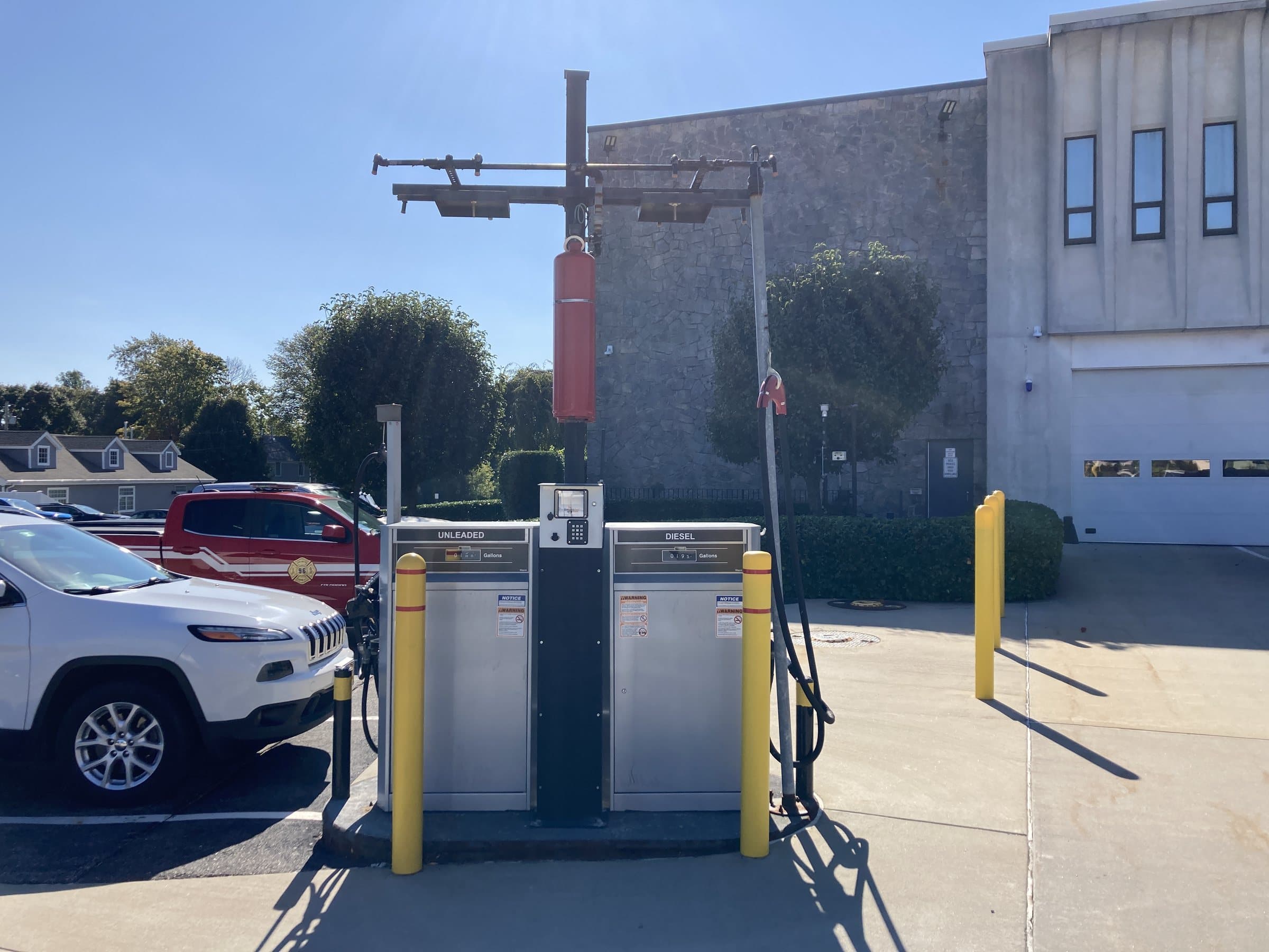 Fuel dispensers with protective bollards at a fleet facility.