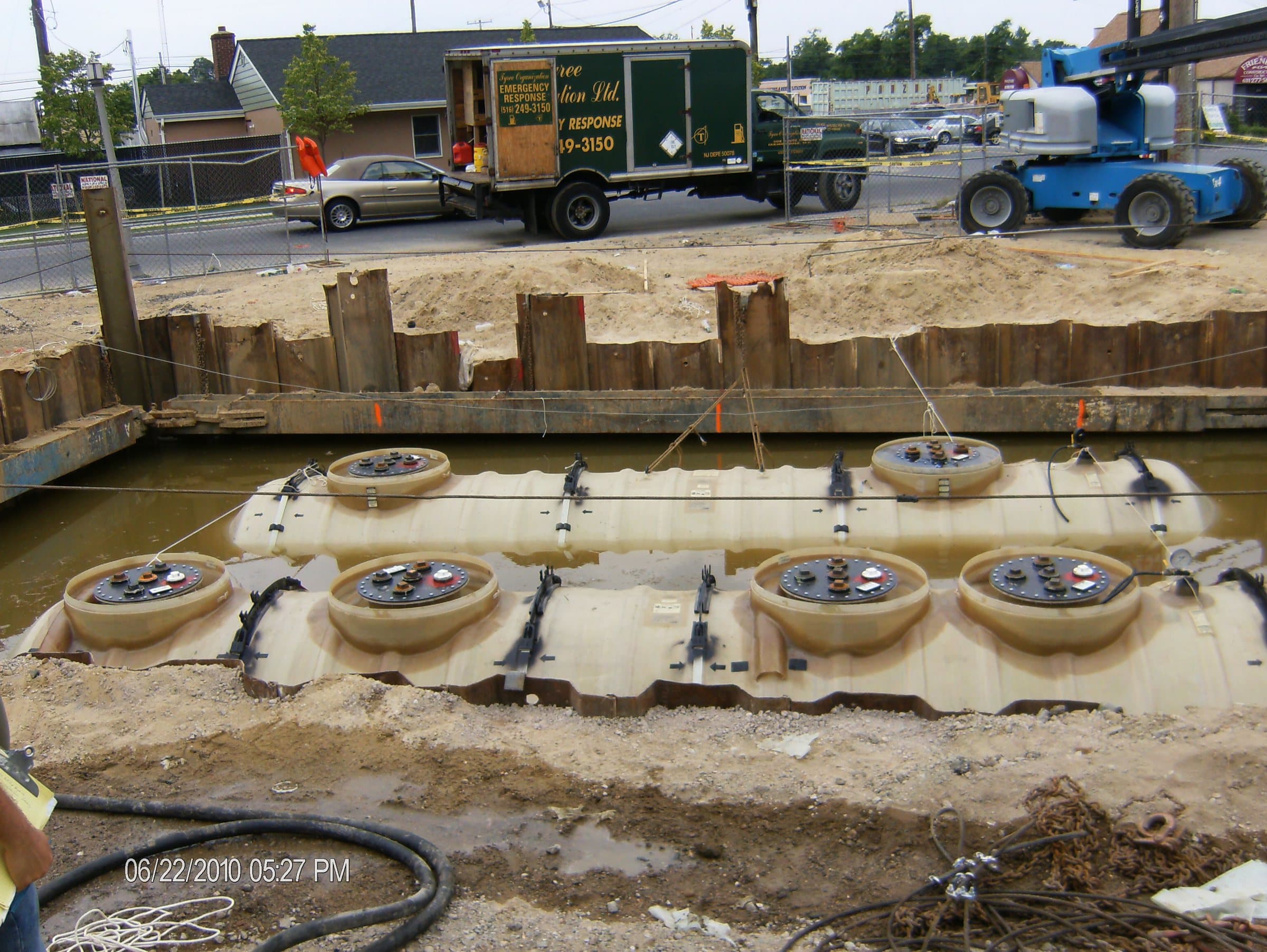 Underground fuel tanks and shoring during installation in wet conditions.