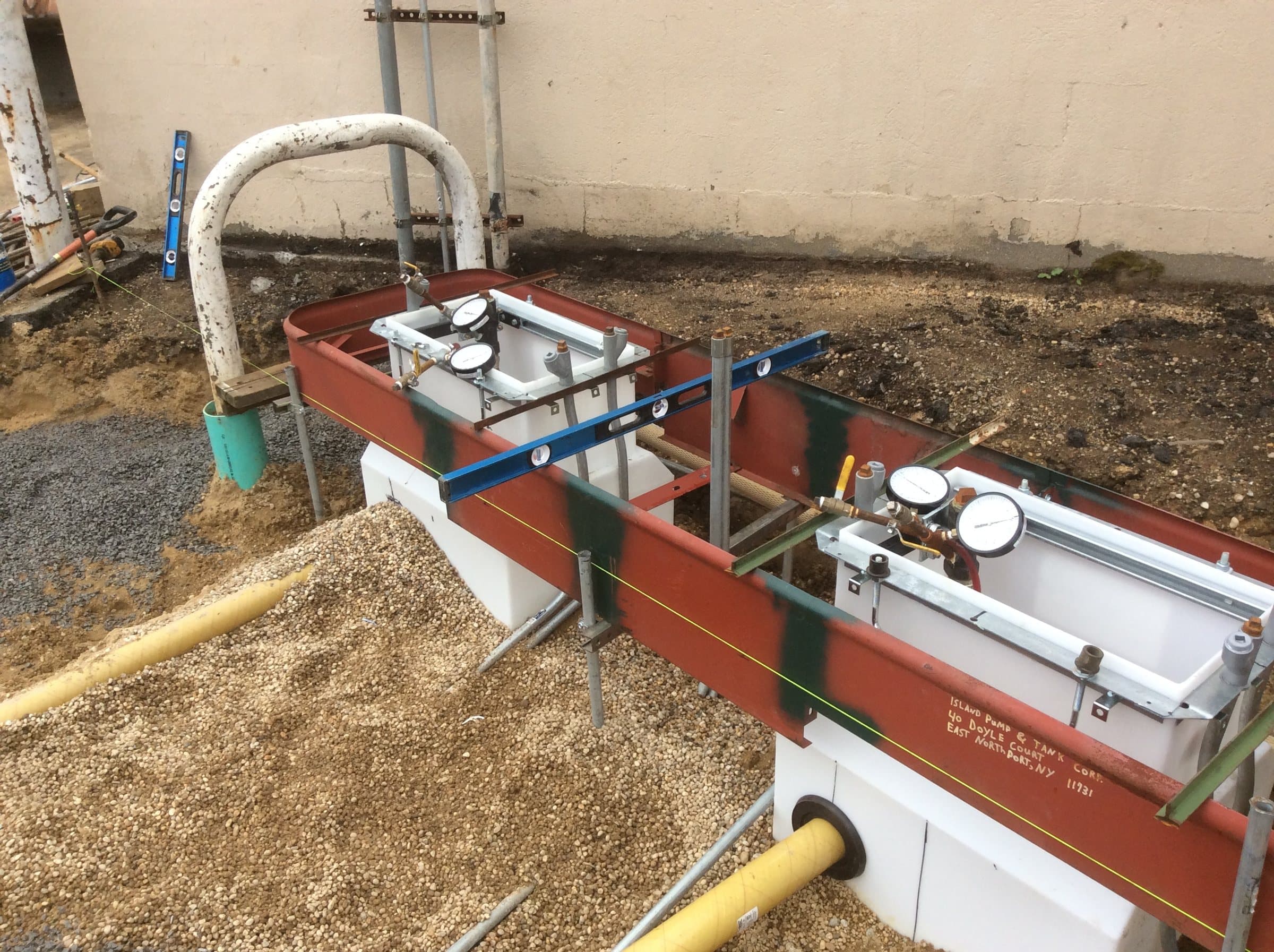 Fuel piping connections within two dispenser sumps during installation.