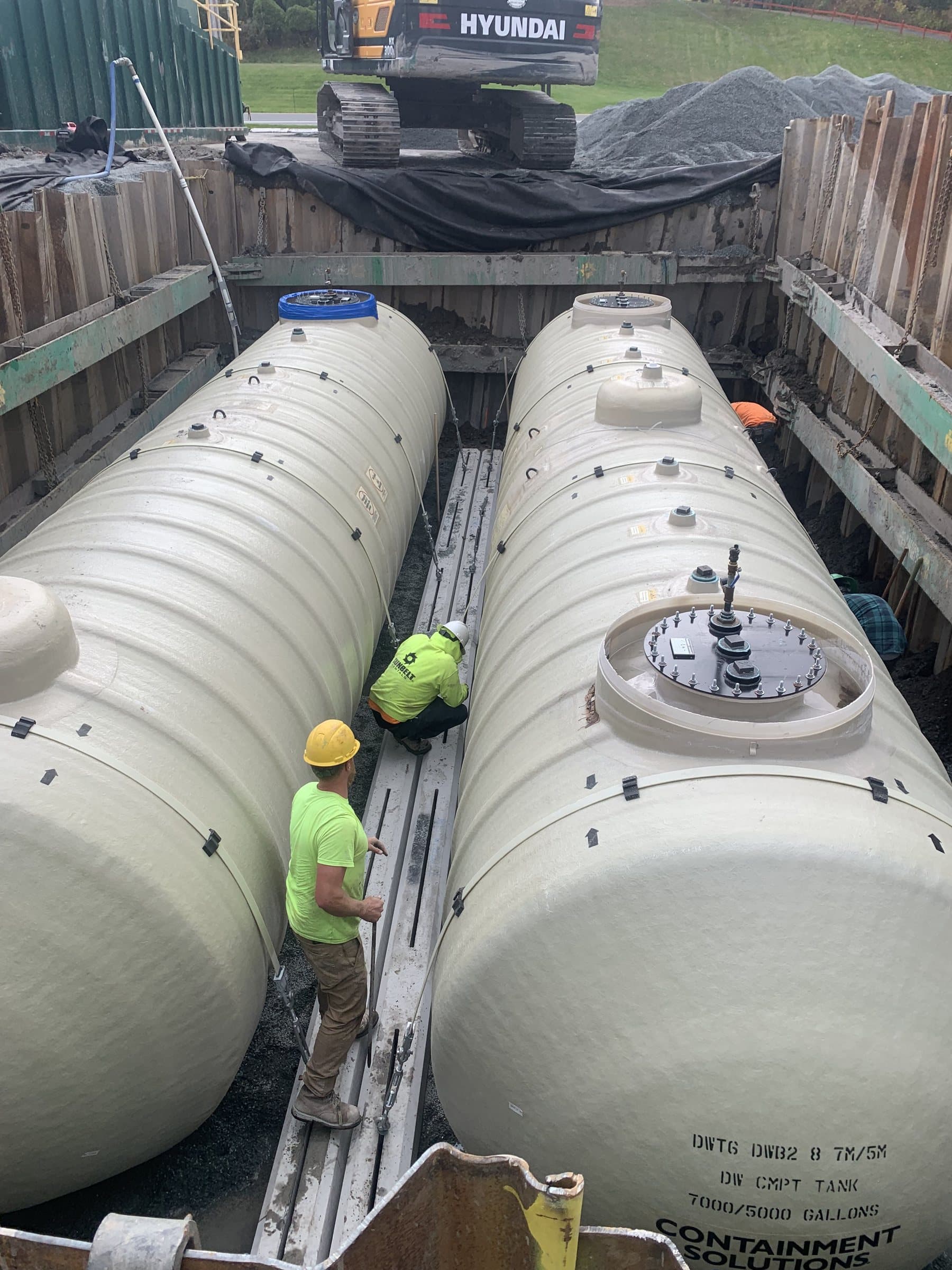 Underground tanks and tank-top equipment during installation.