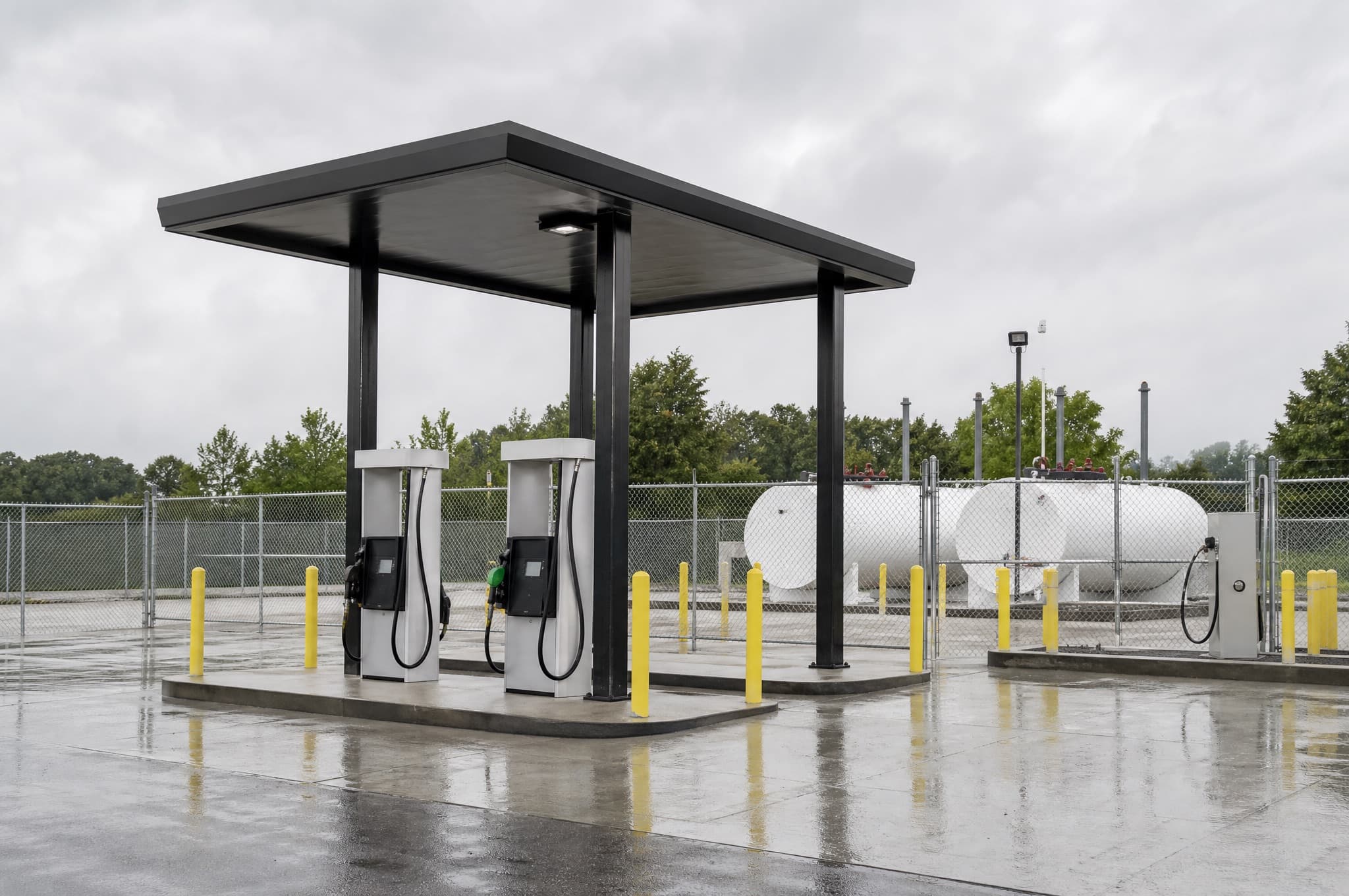Fleet fueling island with dispensers and an aboveground diesel tank at a municipal yard